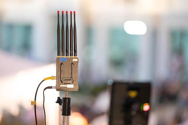 A close-up of a 5G antenna installed within a manufacturing facility, with blurred machinery and workers in the background. The focus is on the antenna, symbolizing the enhanced connectivity it provides.