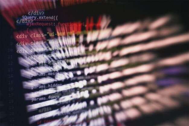 A close-up of a computer screen displaying complex code and algorithms, with an AI icon subtly overlaid, symbolizing the integration of artificial intelligence in cybersecurity systems.