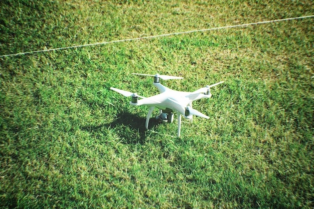 A drone flying over a field, capturing multispectral imagery. The image shows the drone's camera system and the field below with varying colors representing different levels of plant health. This emphasizes the use of technology to assess crop conditions.