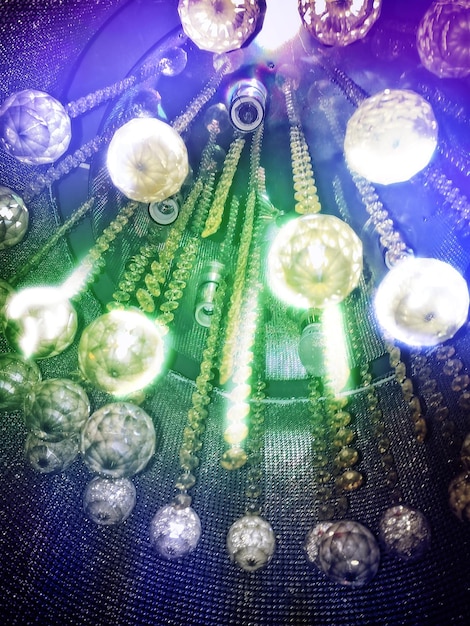 A detailed view of a computer screen displaying a complex network diagram of molecular interactions, overlaid with AI-generated predictions of drug efficacy. The scene is set in a modern research lab.