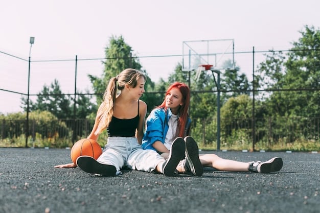 A mother kneeling down to talk to her daughter on the sidelines of a basketball court. The daughter is listening attentively, and the mother is speaking calmly and supportively. The scene conveys a sense of trust and encouragement, highlighting the importance of open communication between parent and child in sports. The lighting is soft and natural, emphasizing the emotional connection between them.