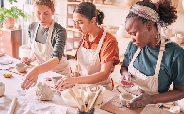 A group of people attending a pottery class in a local studio, with the instructor demonstrating techniques and participants actively engaged in creating their own pieces. The studio is filled with various tools and materials, fostering a creative learning environment.