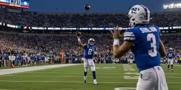 Dynamic quarterback in action with stadium lights and cheering fans, symbolizing the 2025 NFL Draft's top prospects.