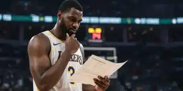 NBA player reviewing contract, symbolizing 2025 CBA impacts